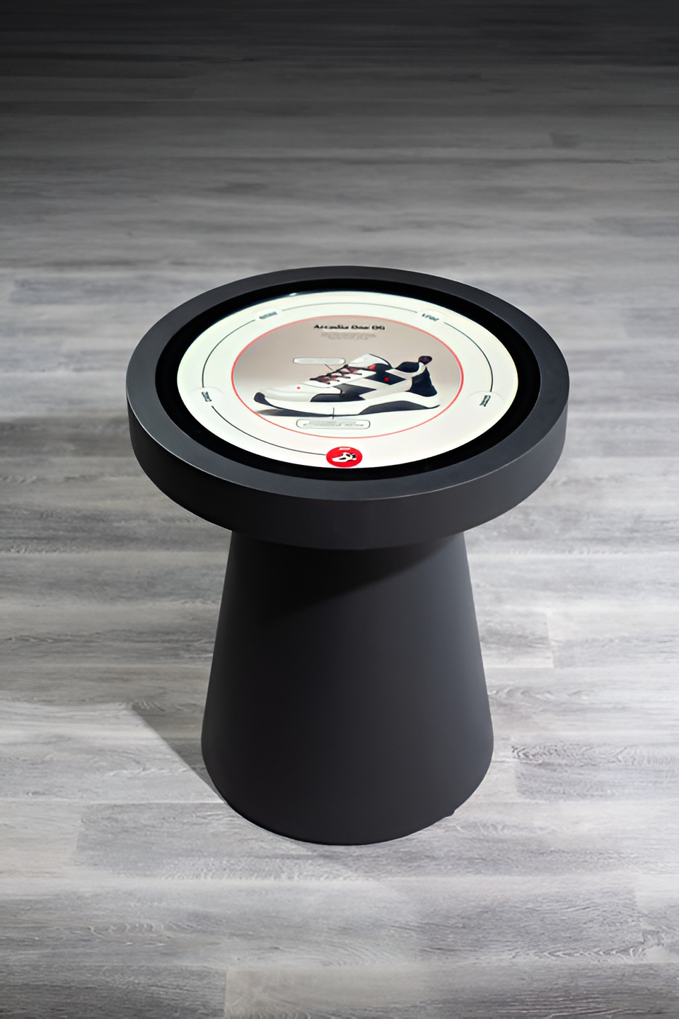 Round interactive touch table displaying a sneaker product page