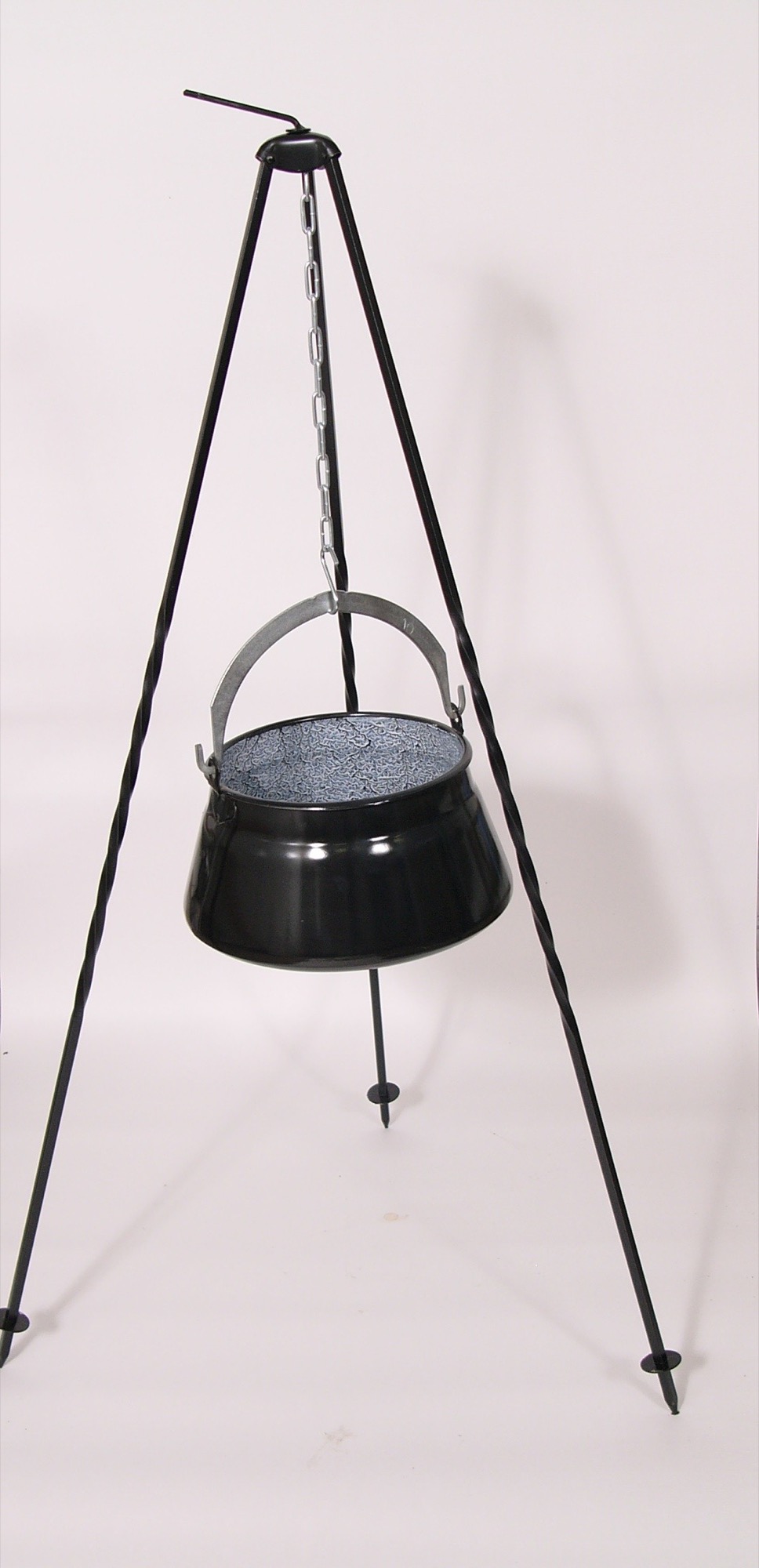 Before: cauldron on a tripod photographed against a pink wall